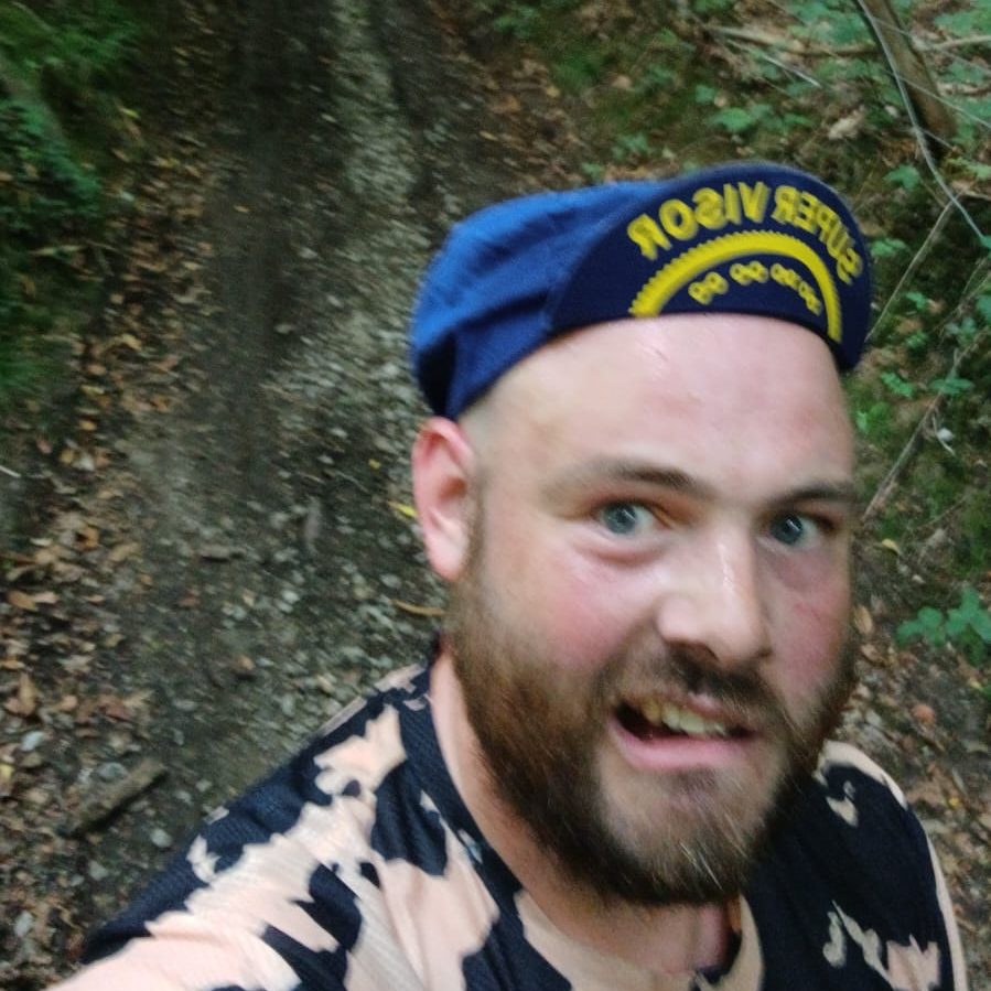 A camera selfie of me being tired and pushing my bike up a hill that was too steep and long for me.