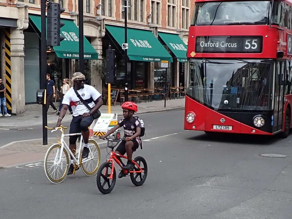 An adult and a child riding their bikes at the Black Unity Bike Ride 2025