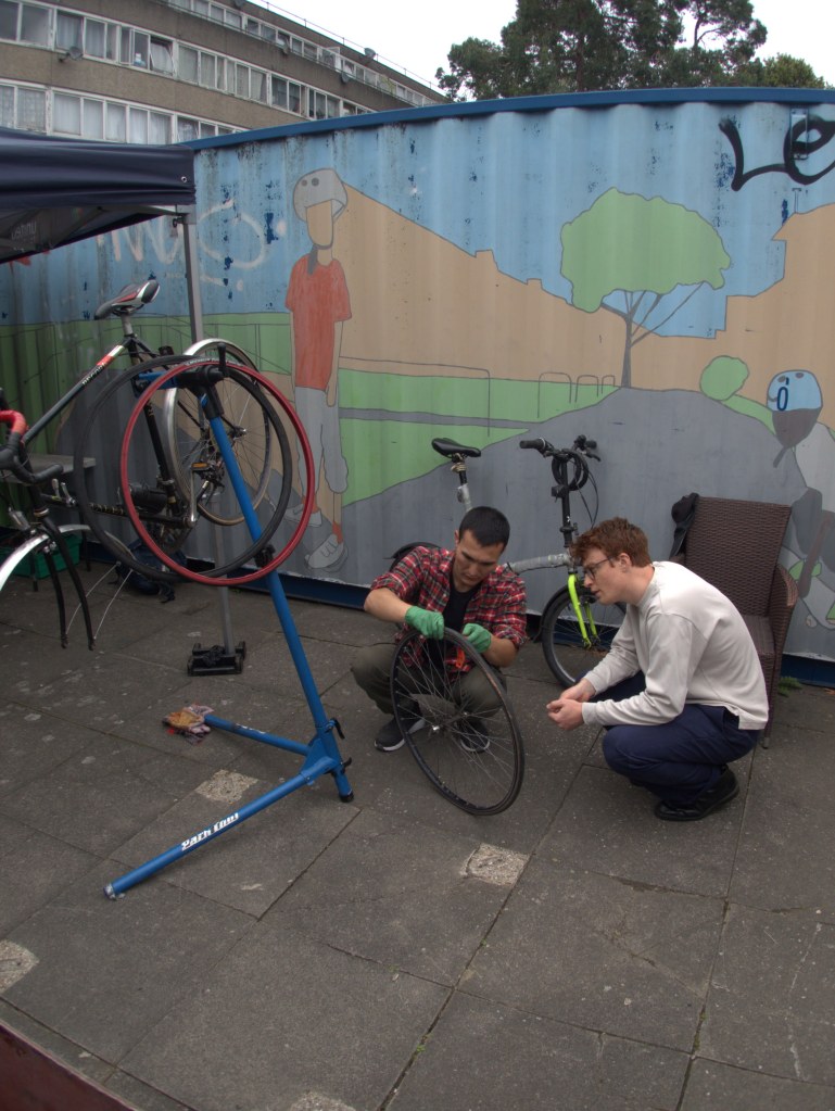 Two people fixing a puncture at Community Cycleworks Bikefix