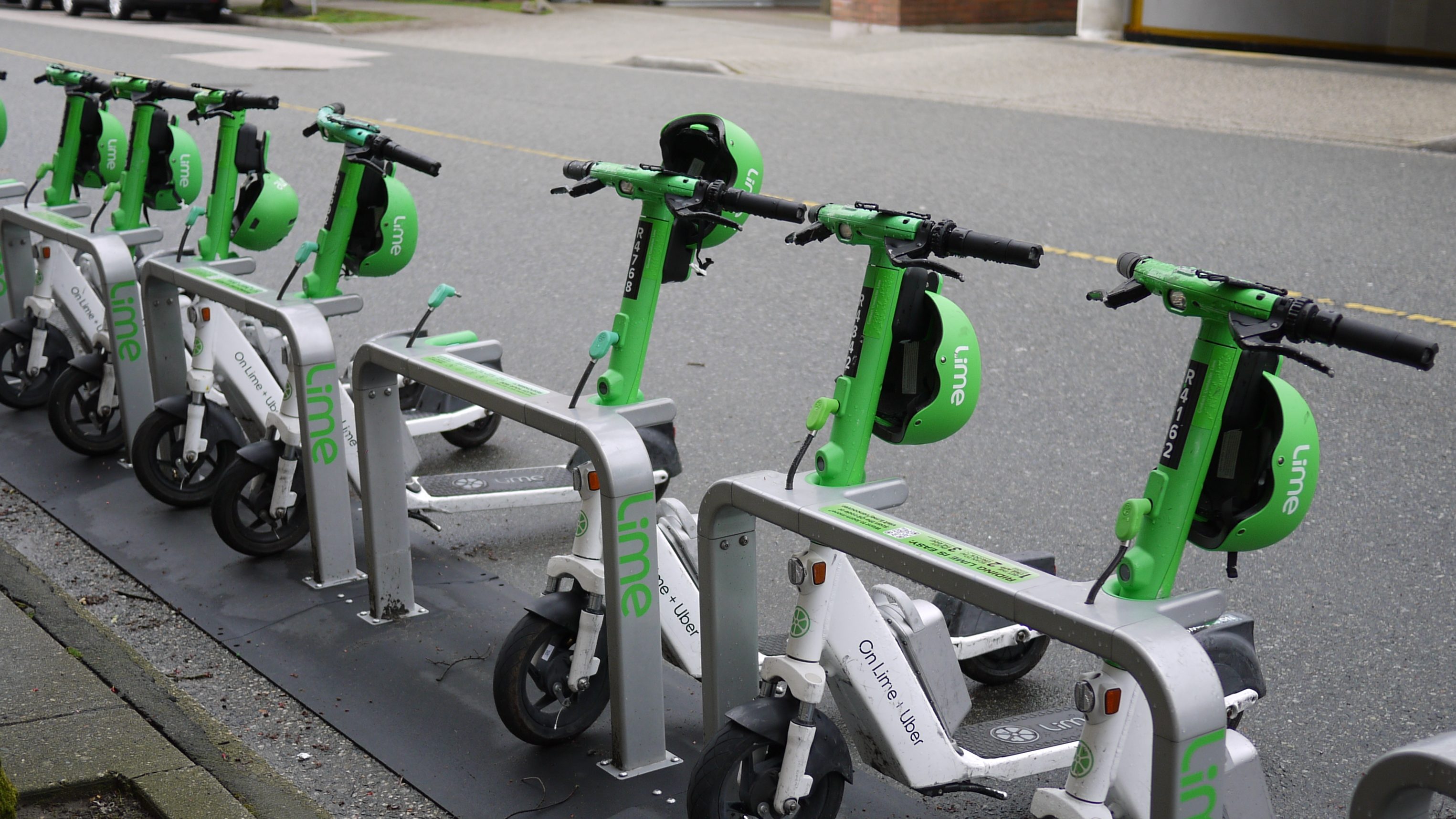 A bay of lime bikes, including with helmets, in Vancouver.